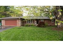Charming brick ranch home featuring an attached two-car garage and lush green front lawn at 8035 Black Oak Ct, Plainfield, IN 46168