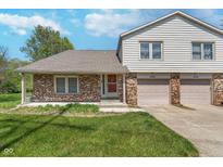 Charming two-story townhome featuring brick and siding exterior with an attached two-car garage at 9162 Cinnebar Dr, Indianapolis, IN 46268