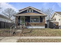 Charming single-Gathering home with brick and blue siding and covered porch at 940 N Chester Ave, Indianapolis, IN 46201