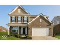 Charming two-story home featuring a two-car garage and nicely landscaped front yard at 10448 Pintail Ln, Indianapolis, IN 46239