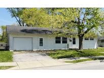Charming single-story home with attached garage, landscaped yard, and mature trees at 107 N Grant St, Brownsburg, IN 46112