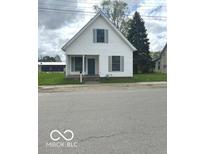Charming white two-story home with a neatly maintained front yard, and inviting curb appeal at 11 W Osage St, Greenfield, IN 46140