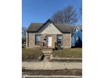 Charming single-story home with brick facade and inviting front porch steps to the entry door at 1342 W Lee St, Indianapolis, IN 46221