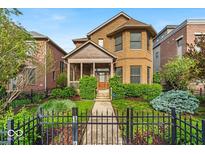 Charming brick home with manicured lawn and black fence in a desirable neighborhood at 1510 Central Ave, Indianapolis, IN 46202