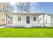 Charming bungalow with a covered porch, white siding, and well-maintained lawn at 2333 Calhoun St, Indianapolis, IN 46203