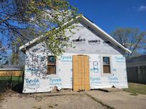 Exterior view of a house under construction with Tyvek HomeWrap and windows installed at 3123 S Rybolt Ave, Indianapolis, IN 46241