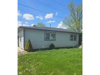 Side view of home, gray siding, dark trim, lawn with weeds, blue sky with scattered clouds at 4006 Kenneth Ave, Indianapolis, IN 46226