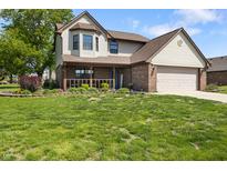 Charming two-story home featuring a covered porch, brick accents, and a well-manicured front yard at 500 Meadowlark Ct, Whiteland, IN 46184