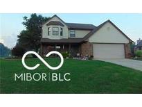 Charming two-story home featuring a brick facade, attached garage, and well-maintained lawn at 500 Meadowlark Ct, Whiteland, IN 46184