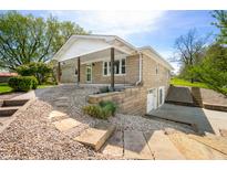 Charming home with stone facade, covered front porch, and landscaped front yard at 5079 S Lick Creek Rd, Morgantown, IN 46160
