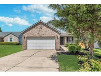 Charming brick home with a well-maintained lawn and two-car garage, perfect for Gathering living at 5622 Imperial Woods Cir, Indianapolis, IN 46224