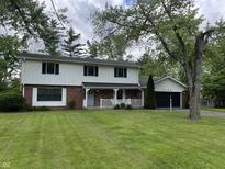 Charming two-story home with brick facade, well-manicured lawn, and attached two-car garage at 7140 Avalon Trail Dr, Indianapolis, IN 46250
