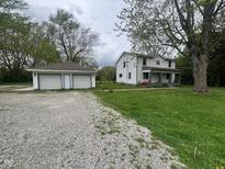 Charming two-story home with a two-car detached garage and ample green space at 728 W 300 N, Anderson, IN 46011