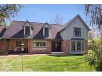 Charming two-story home with a brick facade, dormer windows, and a well-manicured lawn at 7425 E 300 S, Whitestown, IN 46075