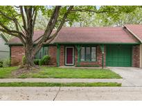 Charming single-story brick home with a well-maintained lawn, red roof, and green trim at 11 Woodacre Dr, Carmel, IN 46032