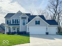 Charming two-story home with a well-manicured lawn and attached three car garage at 1115 Freshwater Ln, Cicero, IN 46034