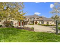 Stunning custom home with circular drive and attached 3 car garage, professionally landscaped at 12010 Landover Ln, Fishers, IN 46037