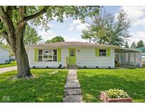 Charming single-story home with neat landscaping, vibrant shutters, and a welcoming walkway at 1212 N 10Th St, Elwood, IN 46036