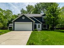 Charming two-story home featuring navy siding, white trim, an attached two-car garage, and a well-manicured lawn at 12577 Pointer Pl, Fishers, IN 46038