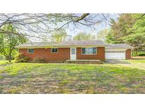 Charming brick ranch-style home with an attached garage and a yard with flowering plants at 3913 E Cr 600 S, Clayton, IN 46118