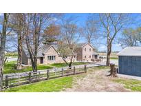 Charming brick home with a large front yard, wooden fence, and mature trees at 4155 S State Rd 39, Lebanon, IN 46052