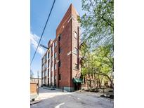 Charming brick building with large windows and well-maintained landscaping; fire escape stairs provide vintage touch at 624 E Walnut St # 46, Indianapolis, IN 46204