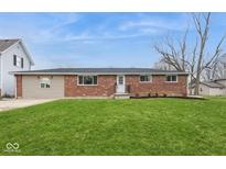 Charming single-story brick home with a well-manicured lawn at 828 N 13Th St, Elwood, IN 46036