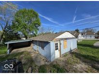 Cozy home exterior featuring a carport and a traditional roof design set against a blue sky at 100 N Blue River Dr, Edinburgh, IN 46124