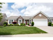 Charming brick home with manicured lawn, lush landscaping, and a two-car garage at 16204 Oakford Trl, Fishers, IN 46037