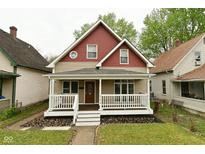 Charming two-story home with a covered front porch and nicely landscaped yard at 344 N Addison St, Indianapolis, IN 46222