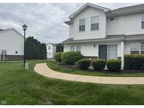 Well-maintained condo with manicured landscaping and a sidewalk leading to the entrance at 4948 Potomac Square Pl, Indianapolis, IN 46268