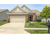 Charming single-story home with brick accents, a two-car garage, and a well-maintained front yard at 5110 Lilium Dr, Plainfield, IN 46168