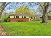 Charming ranch home with a brick accent, covered porch and beautiful, mature trees at 6340 Monitor Ln, Indianapolis, IN 46220