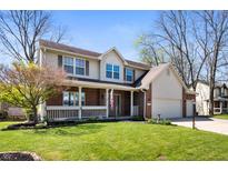 Charming two-story home with brick facade, well-manicured lawn, and attached two car garage at 6373 Thornridge Dr, Avon, IN 46123