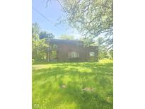 View of a brick home with vines growing on it and a lawn in the front at 6403 W Ralston Rd, Indianapolis, IN 46221