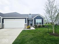 Charming single-story home with a two-car garage and a well-manicured lawn in a lovely neighborhood at 7141 Lillian Pl, Cumberland, IN 46229