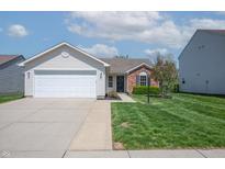 Charming single-story home with a well-manicured lawn and attached two-car garage at 7652 Wood Stream Dr, Indianapolis, IN 46239