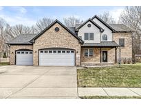 Stunning brick two-story home with attached two car garage and well-maintained lawn at 769 Raintree Dr, Avon, IN 46123