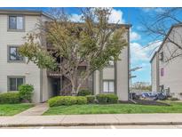 Attractive condo exterior featuring vinyl siding and mature landscaping around the building at 8140 Shorewalk Dr # C, Indianapolis, IN 46236