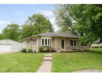 Charming single-story home featuring a stone facade, manicured lawn, and a walkway to the front entrance at 840 N Indiana St, Mooresville, IN 46158
