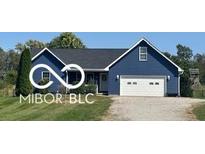 Charming one-story home with blue siding, a two-car garage, and a well-maintained front yard at 911 Centennial Rd, Martinsville, IN 46151