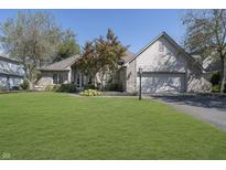 Charming single-story brick home with a well-manicured lawn and a neatly landscaped front yard at 11697 Whisper Bay Ct, Carmel, IN 46033
