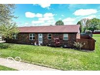 Brick ranch-style home features a well-manicured lawn and inviting curb appeal at 1355 Ash Ct, Martinsville, IN 46151