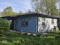 Single-story home featuring light blue siding and a well-maintained roof at 1817 Sparrow Ave, Indianapolis, IN 46227