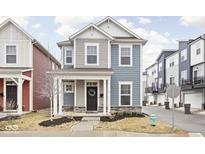 Charming two-story home with covered porch and stone accents on the facade at 214 Handley St, Indianapolis, IN 46222