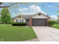 Charming single-story home featuring a two-car garage, manicured lawn, and inviting curb appeal at 308 Creekstone Ct, Indianapolis, IN 46239