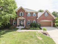 Charming two-story brick home featuring a landscaped yard, attached garage, and inviting entrance at 3601 Lakeshore Ct, Greenwood, IN 46143