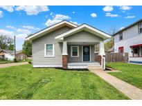 Charming home with a gray exterior, covered front porch, and well-maintained lawn, creating a welcoming curb appeal at 364 Congress Ave, Indianapolis, IN 46208