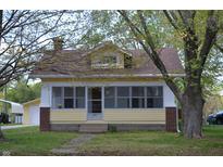 Charming yellow home with brick accents and a cozy front porch at 4736 Madison Ave, Indianapolis, IN 46227