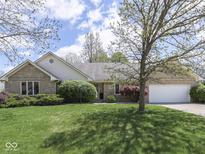 Well-maintained front yard with mature landscaping, brick exterior, and attached two-car garage at 4759 Silver Hill Dr, Greenwood, IN 46142